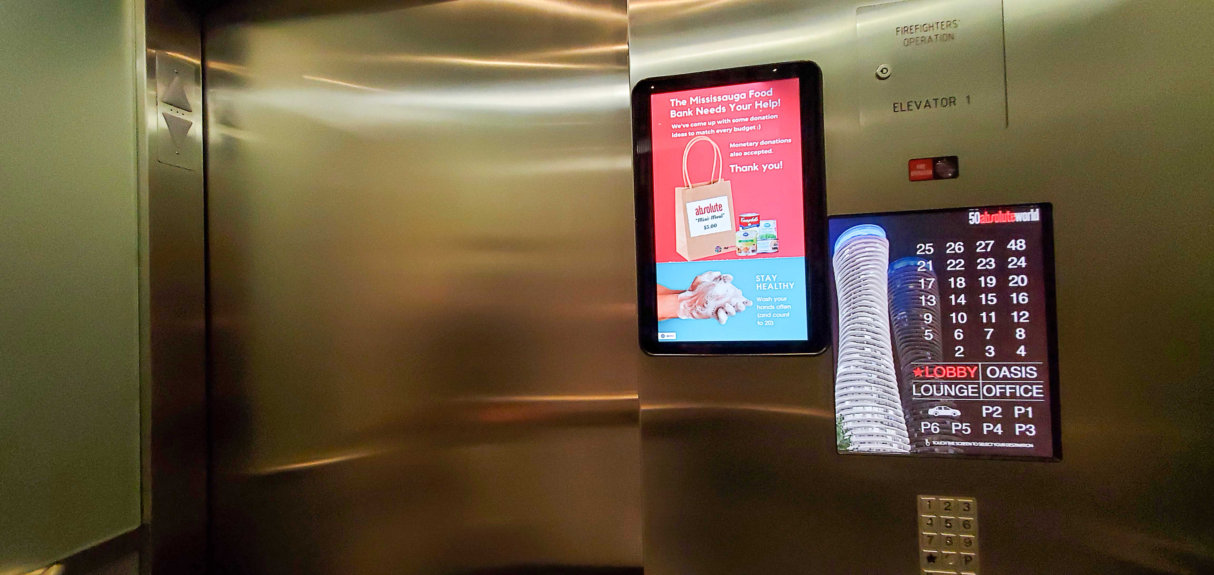 Image of elevator with touchscreen from Touch to Go Technologies and resident notice screen from DigiNotice