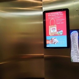 Image of elevator with touchscreen from Touch to Go Technologies and resident notice screen from 